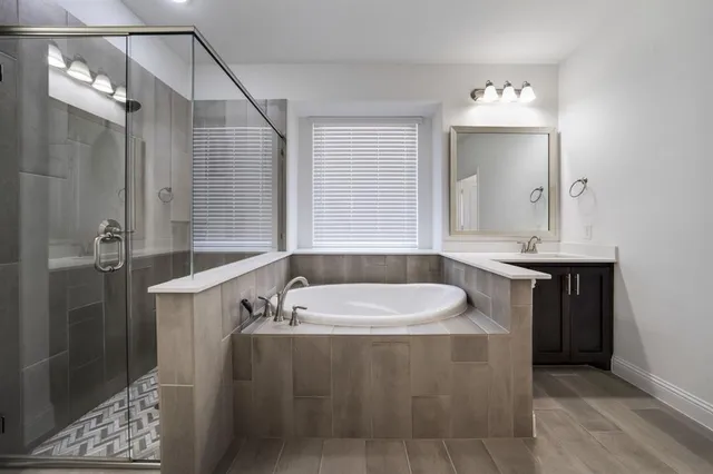 a bathroom with a bathtub sink and mirror