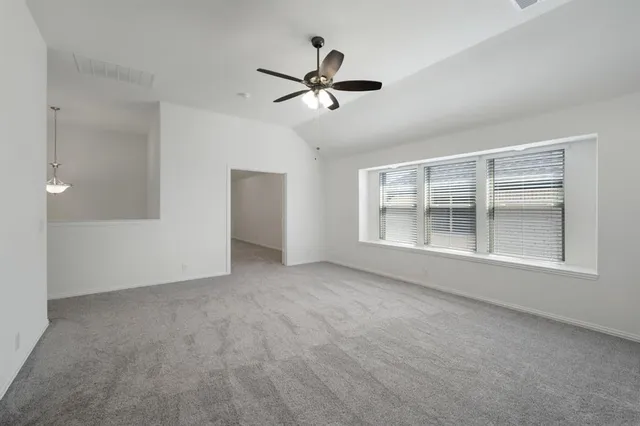 a view of an empty room with a window