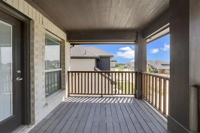 a view of a balcony with wooden floor