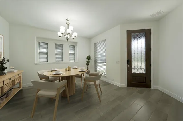 a view of a dining room with furniture and window