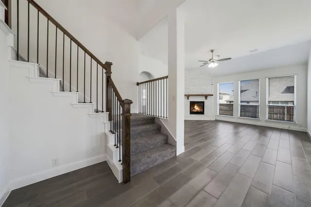 a view of a livingroom with wooden floor and stairs