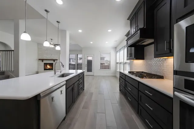 a kitchen with stainless steel appliances granite countertop a stove and a sink