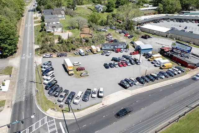 an aerial view of a swimming pool with outdoor seating