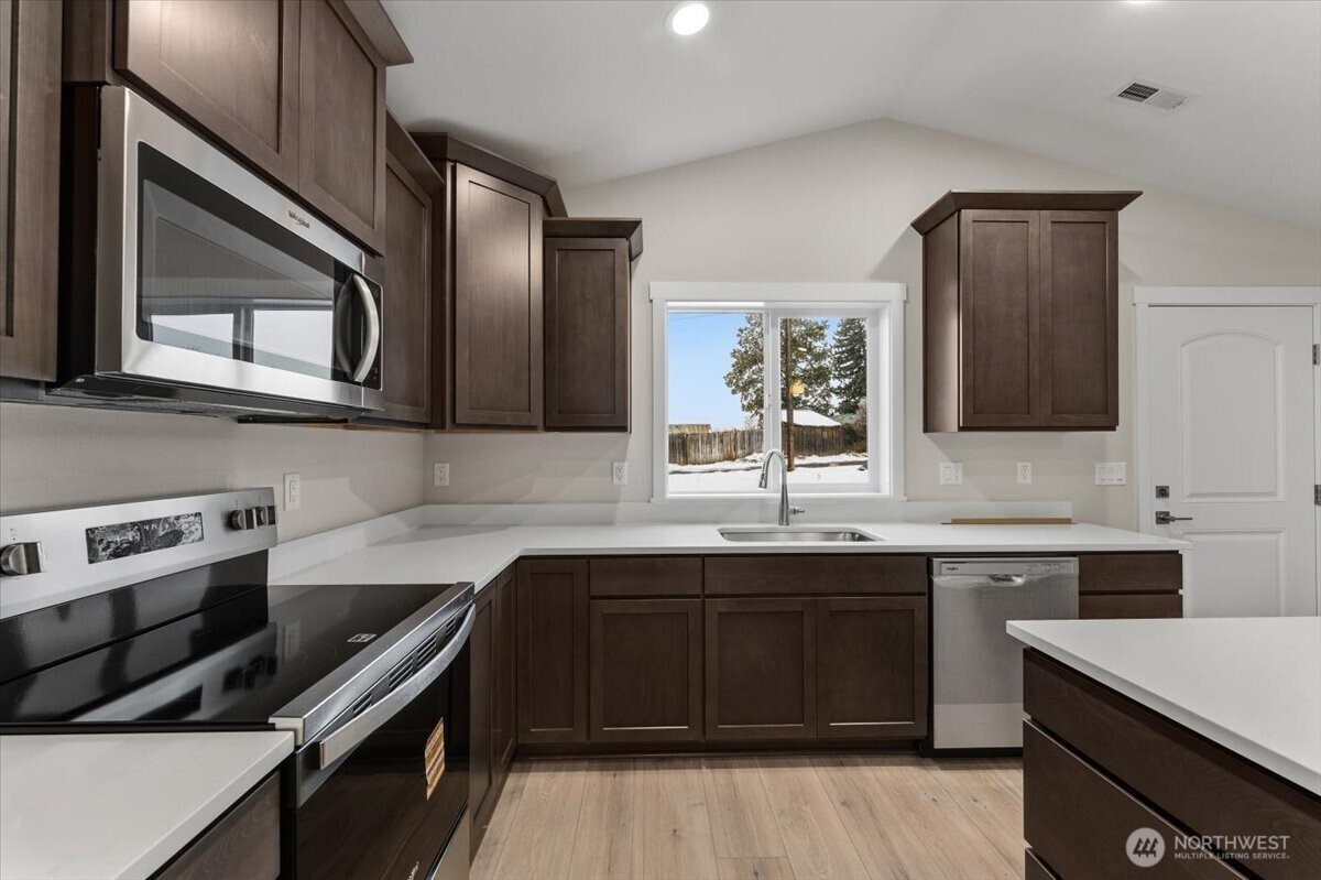 36 Simpson Street Mansfield, WA 98830 - Photo 10 of 28 a kitchen with stainless steel appliances a sink stove and cabinets