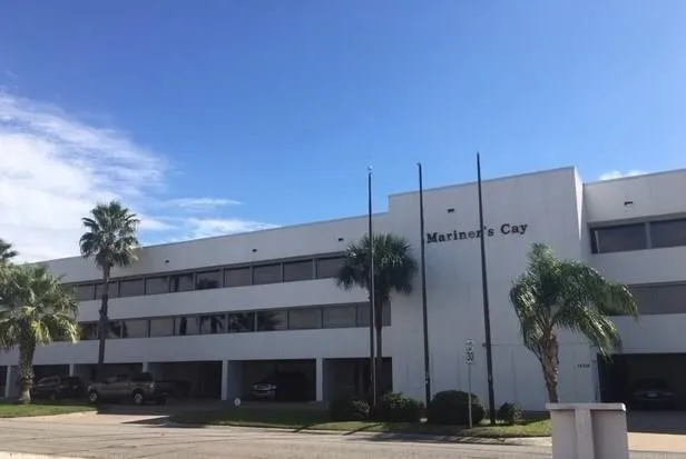 a view of a tall building next to a yard