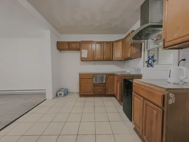 a kitchen with a sink a stove top oven and cabinets