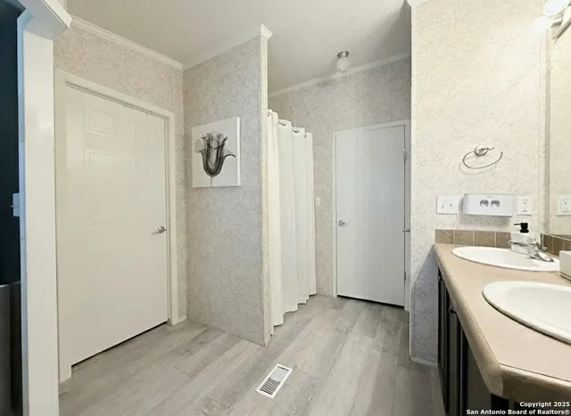 a bathroom with a granite countertop sink a toilet a mirror and shower