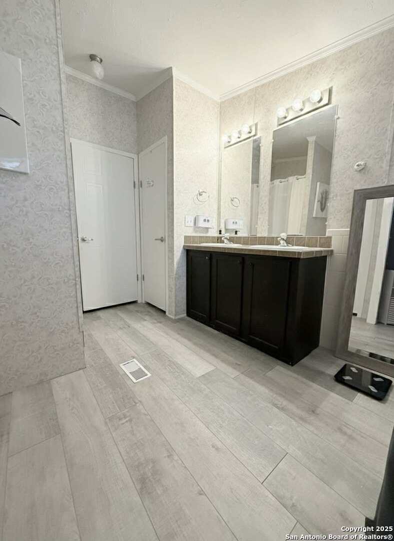 202 South 10th Christine, TX 78012 - Photo 15 of 28 a view of a double vanity sink and a mirror in a room