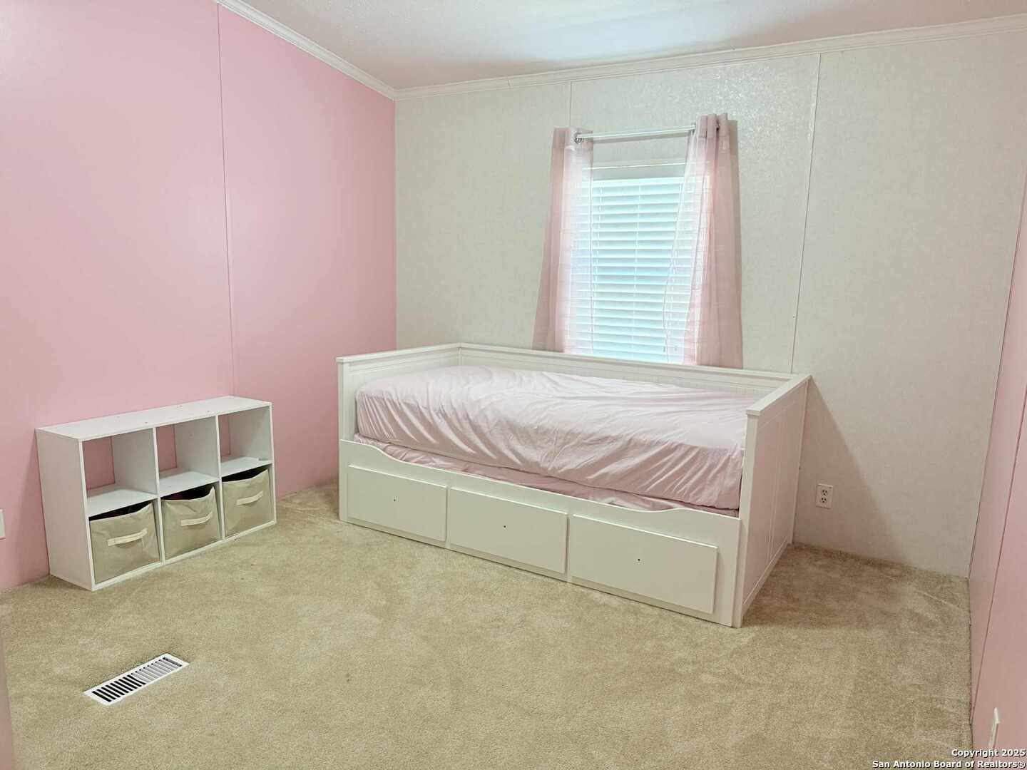 202 South 10th Christine, TX 78012 - Photo 18 of 28 a bedroom with a bed and a cabinets