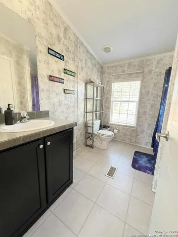 a spacious bathroom with a tub sink and mirror