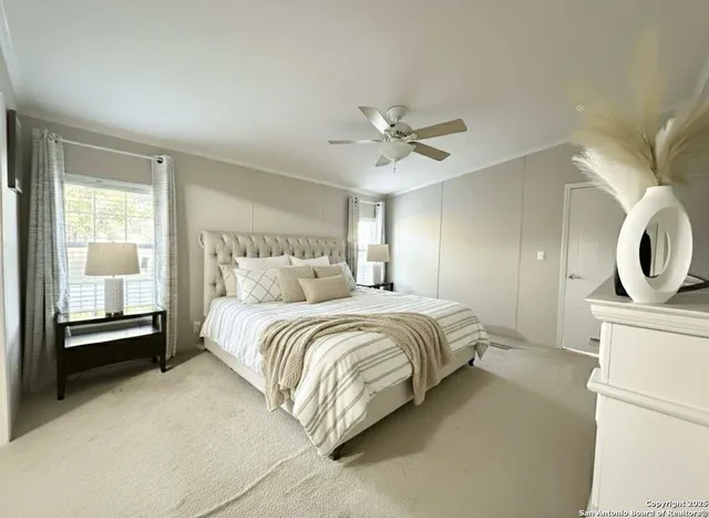 a spacious bedroom with a bed a couch and a window