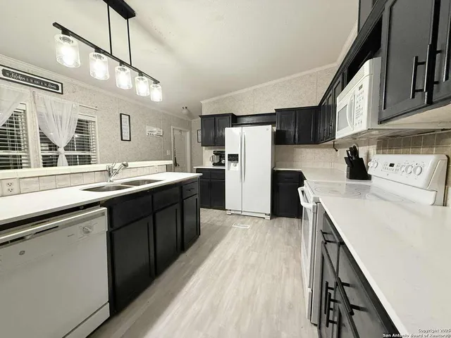 a kitchen with refrigerator and cabinets