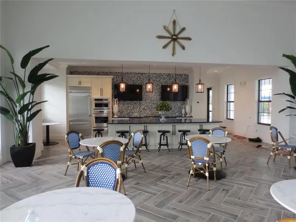 a view of a dining room with furniture and chandelier