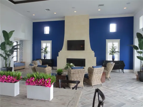 a lobby with furniture and potted plants