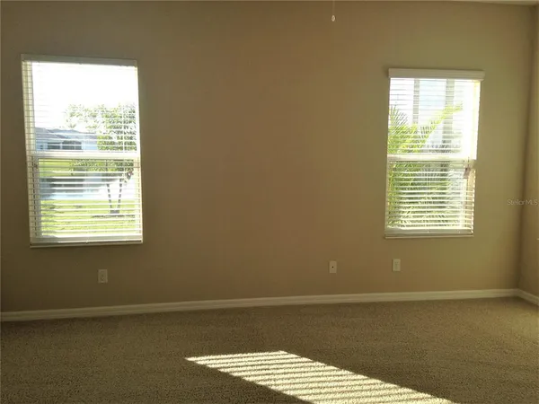 a view of a room with wooden floor and a window
