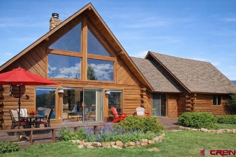 a front view of a house with sitting area
