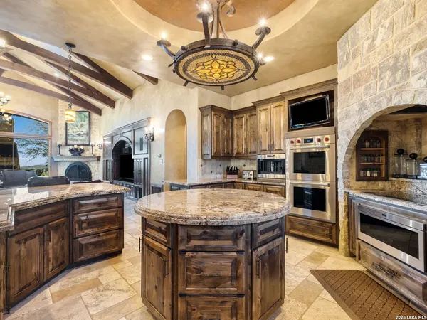 a bathroom with a double vanity sink mirror and shower