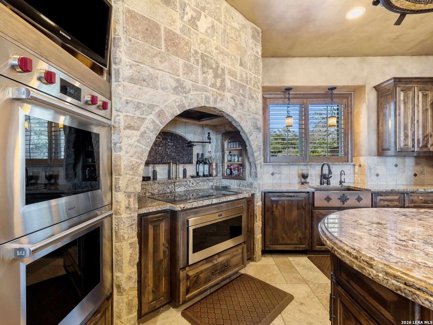 14454 Santa Rita Helotes, TX 78023 - Photo 14 of 70 a kitchen with stainless steel appliances granite countertop a stove and a sink
