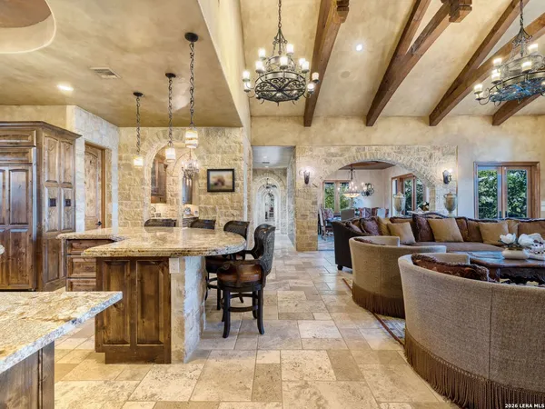 a spacious bedroom with a bed mirror and a large window