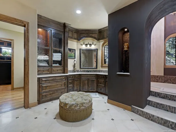 a bathroom with a granite countertop sink a mirror and a shower