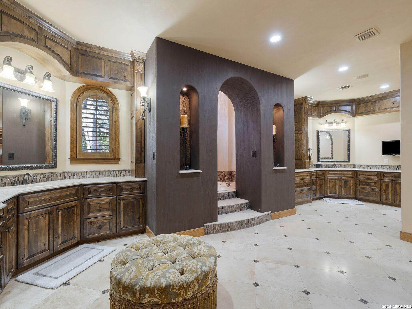 14454 Santa Rita Helotes, TX 78023 - Photo 30 of 70 a spacious bathroom with a double vanity sink and a large mirror