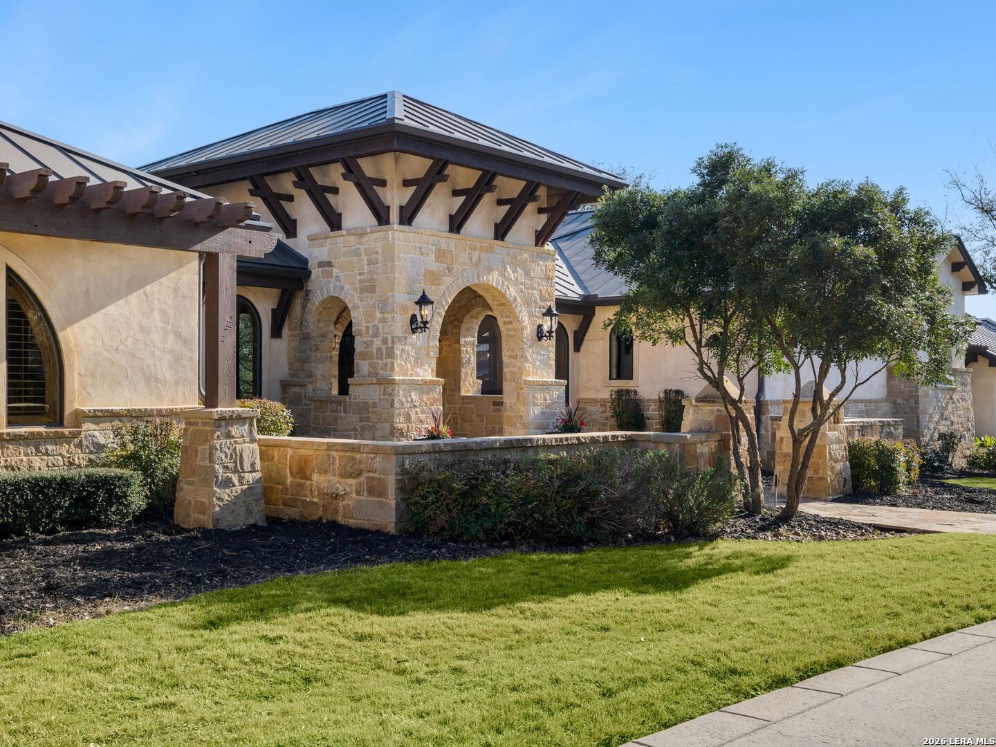 14454 Santa Rita Helotes, TX 78023 - Photo 3 of 70 a front view of a house with a garden