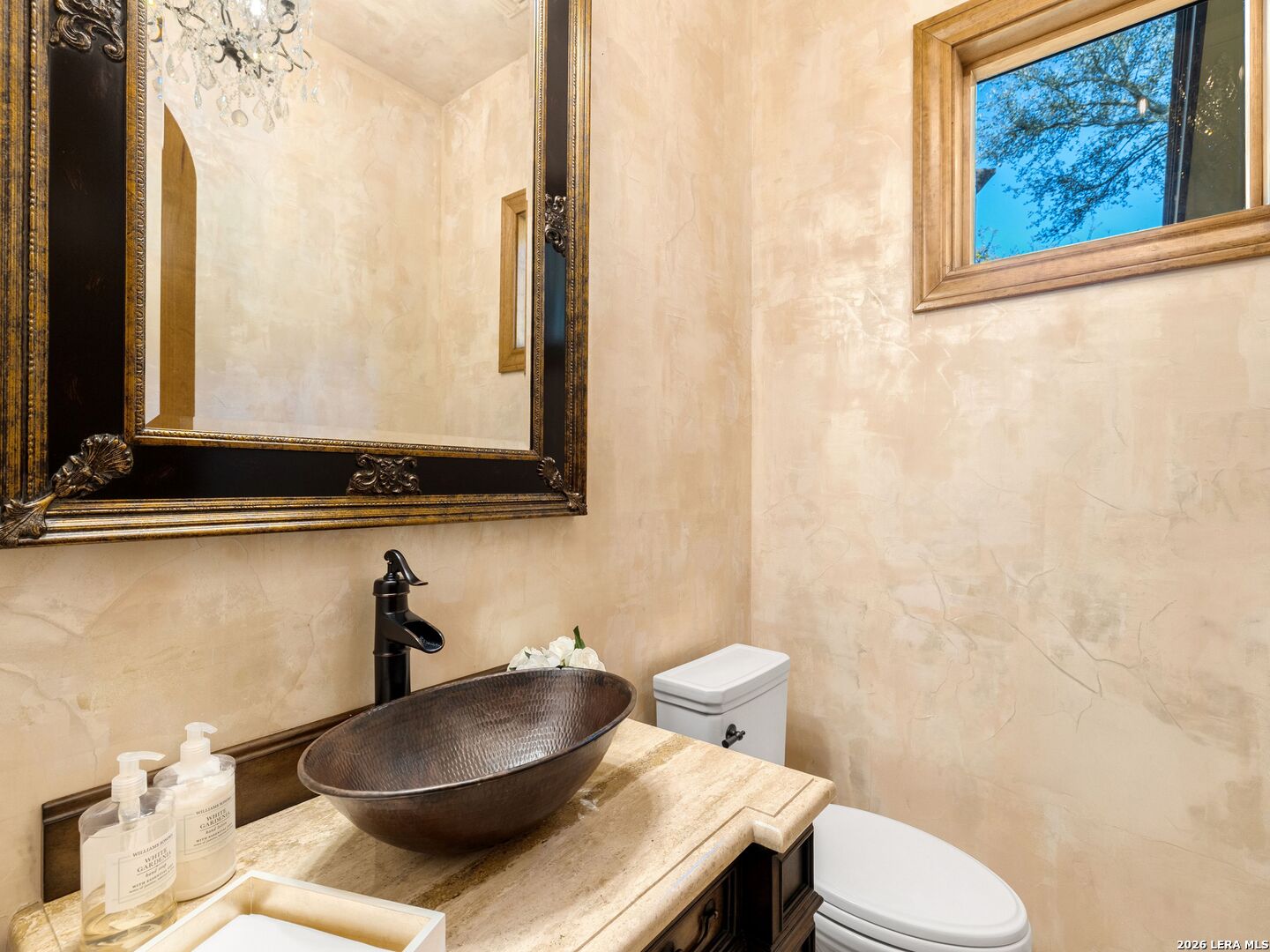 14454 Santa Rita Helotes, TX 78023 - Photo 33 of 70 a bathroom with a toilet a sink and a mirror