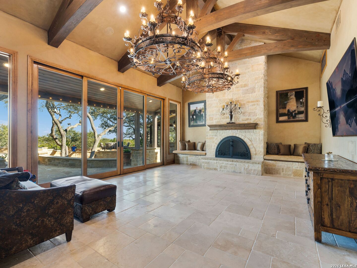 14454 Santa Rita Helotes, TX 78023 - Photo 34 of 70 a living room with furniture a fireplace and a chandelier