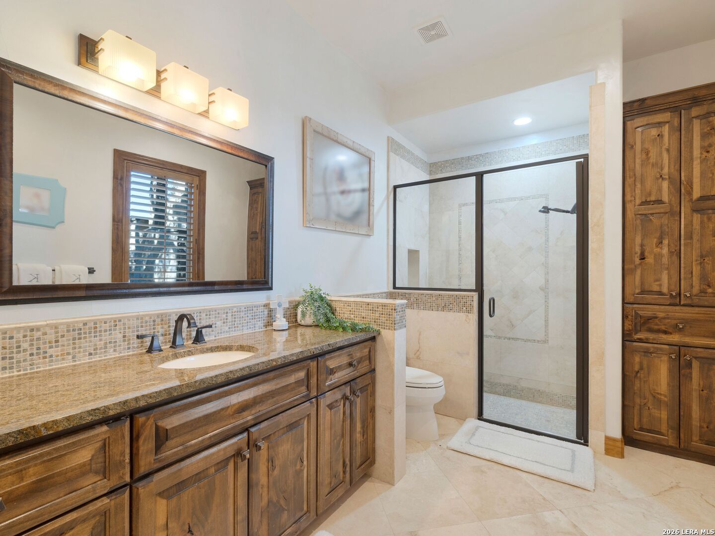 14454 Santa Rita Helotes, TX 78023 - Photo 37 of 70 a bathroom with a granite countertop sink toilet and shower