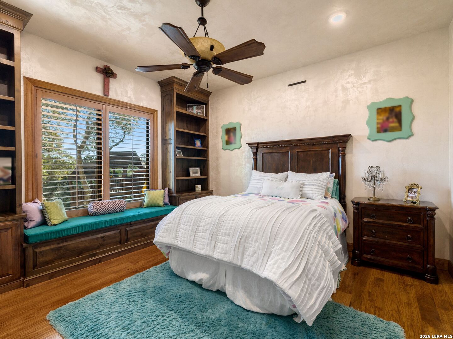 14454 Santa Rita Helotes, TX 78023 - Photo 40 of 70 a bedroom with a bed a dresser and a window