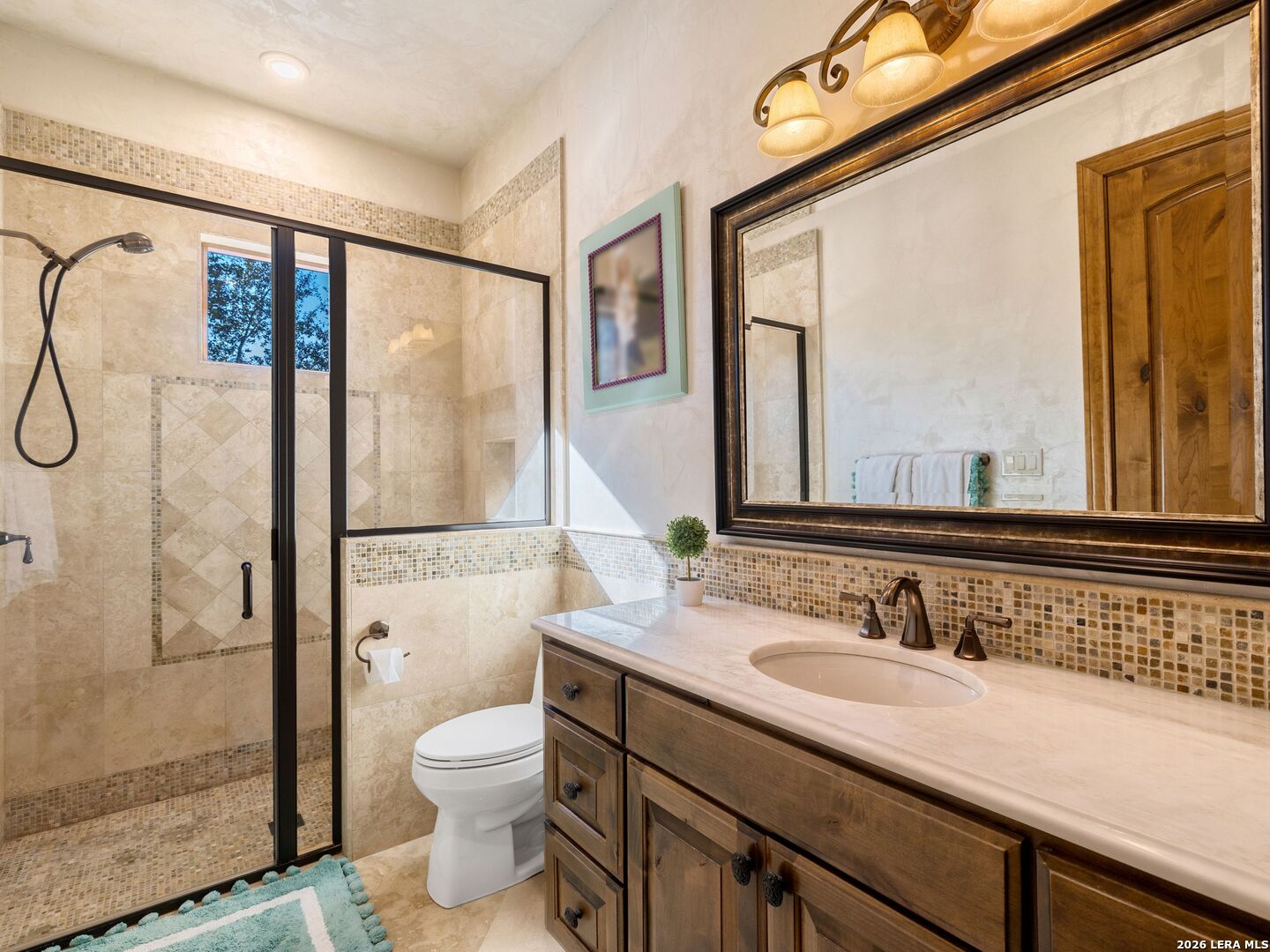 14454 Santa Rita Helotes, TX 78023 - Photo 41 of 70 a bathroom with a granite countertop sink toilet and shower