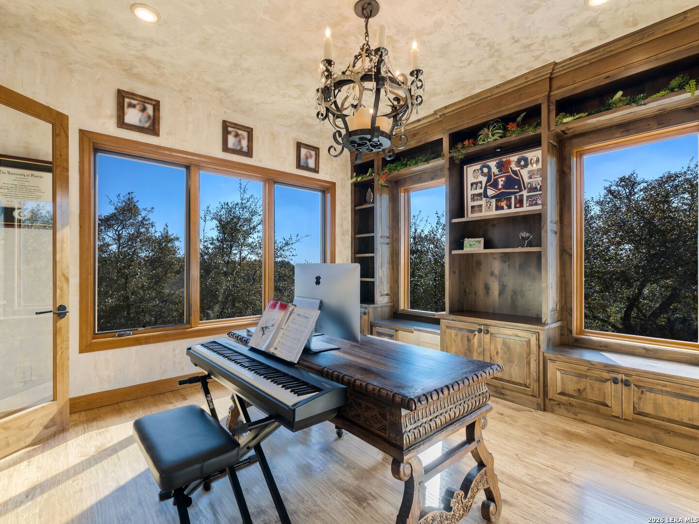 14454 Santa Rita Helotes, TX 78023 - Photo 43 of 70 a living room with furniture a flat screen tv and a floor to ceiling window