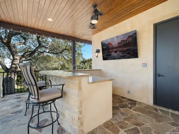 a view of a playground with a patio and fire pit