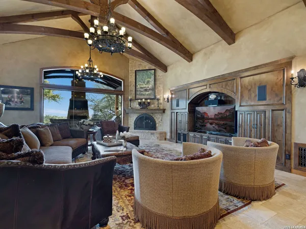 a living room with furniture chandelier and a chandelier