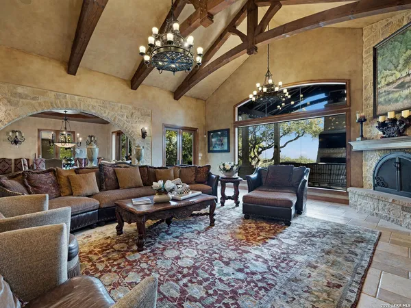 a dining room with furniture a window and a chandelier