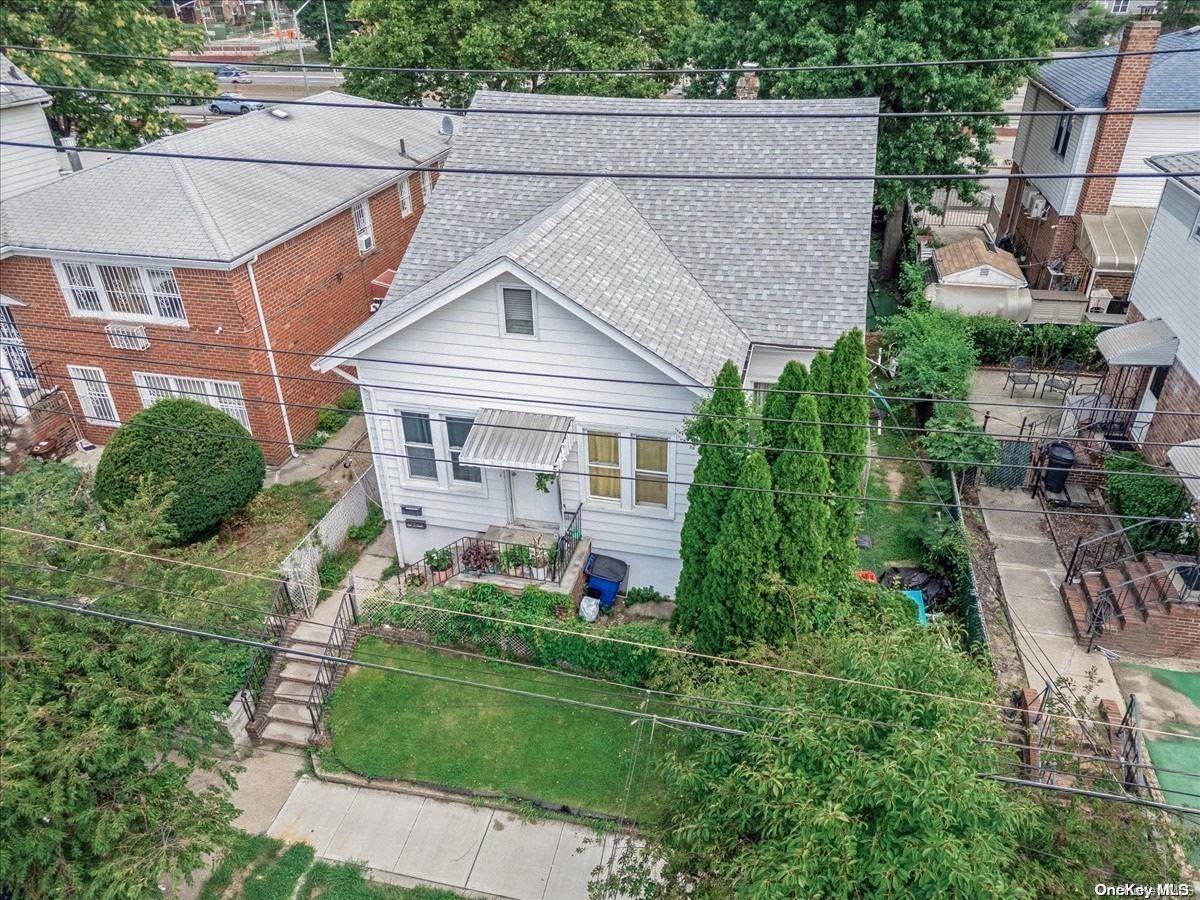 136-19 61st Road Queens, NY 11367 - Photo 1 of 1 a front view of a house with a yard