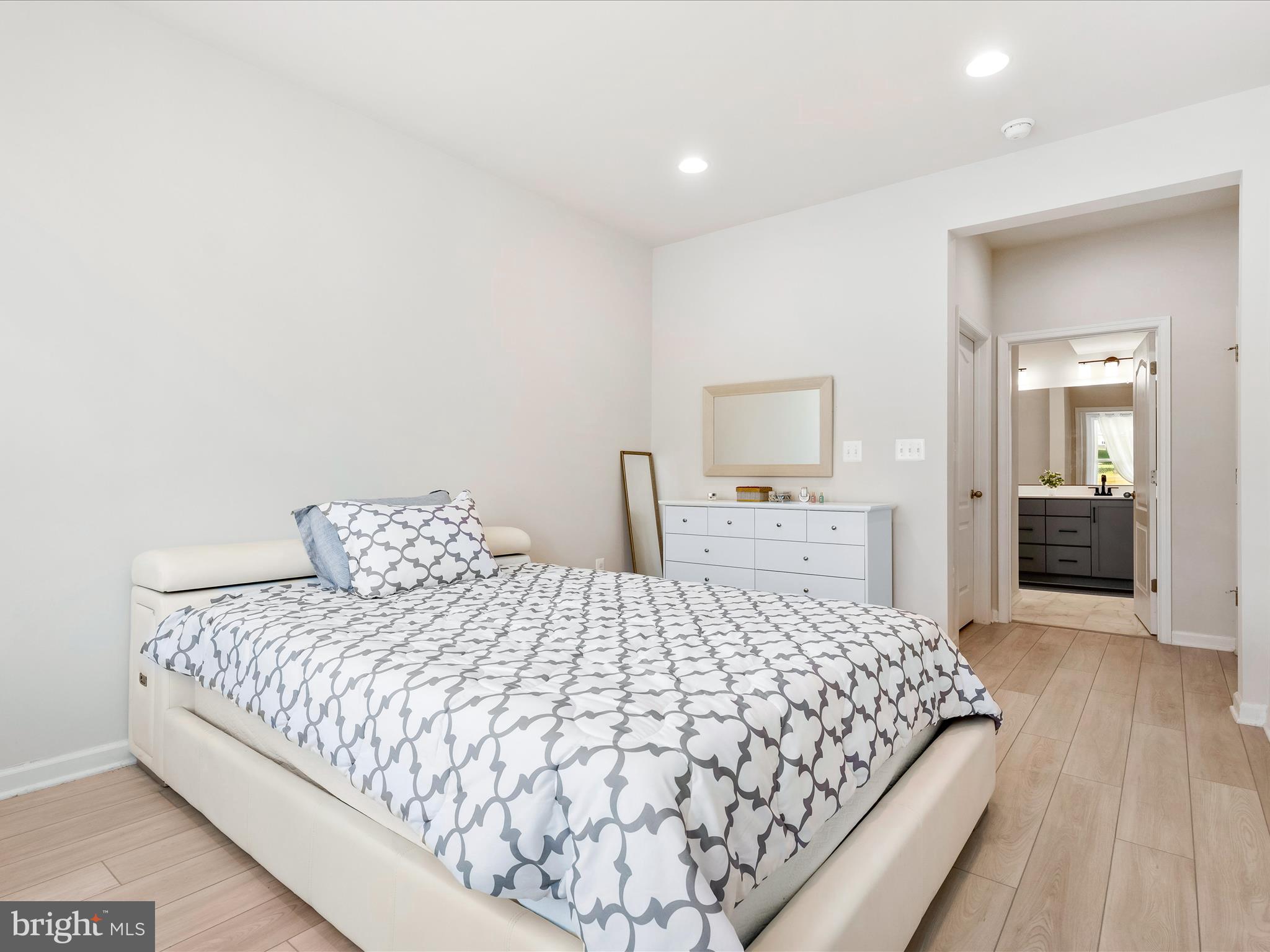 13444 Petrel Street Clarksburg, MD 20871 - Photo 15 of 45 a bedroom with a large bed and wooden floor