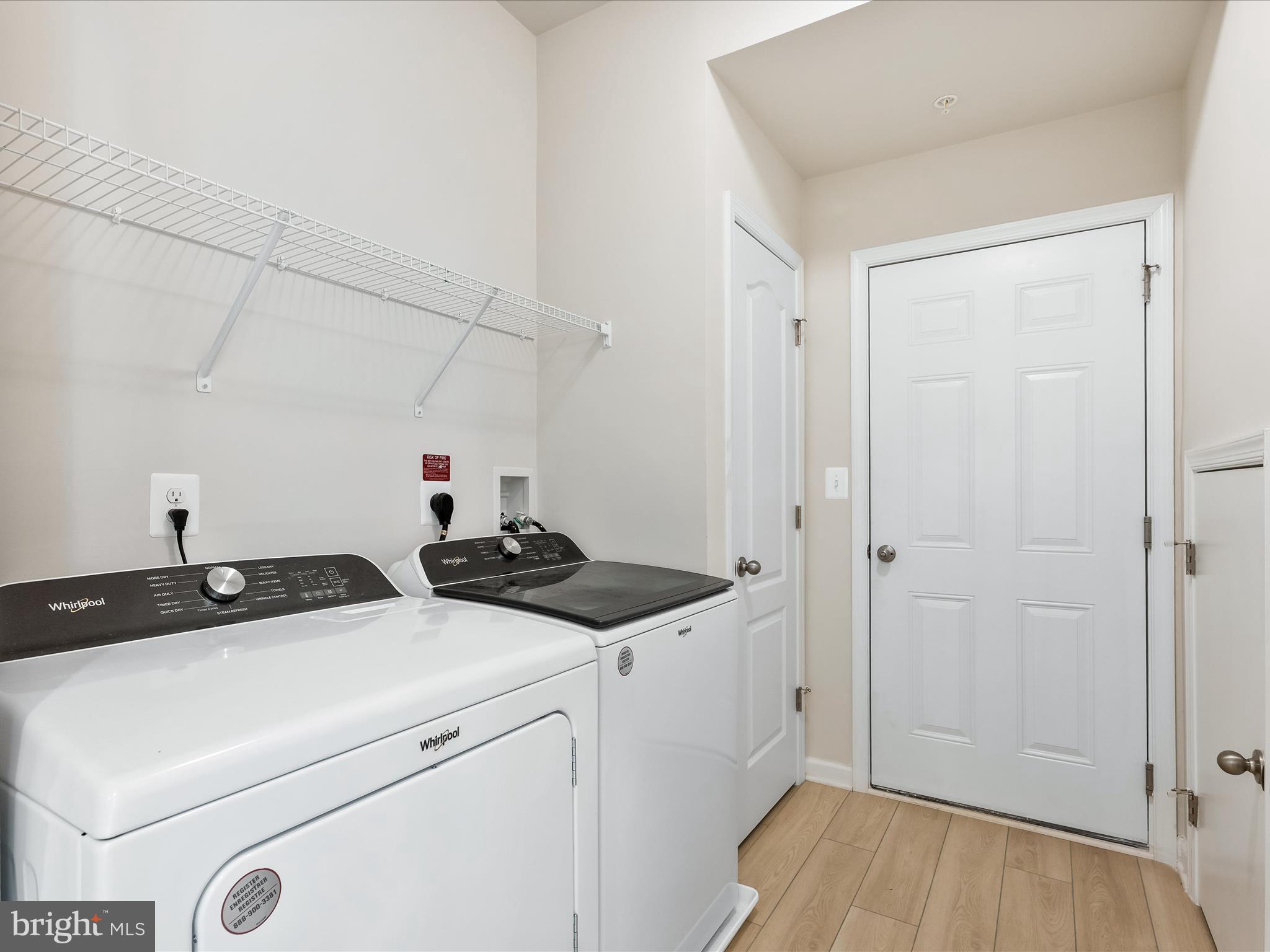 13444 Petrel Street Clarksburg, MD 20871 - Photo 20 of 45 a view of storage and utility room with closet dryer and washer