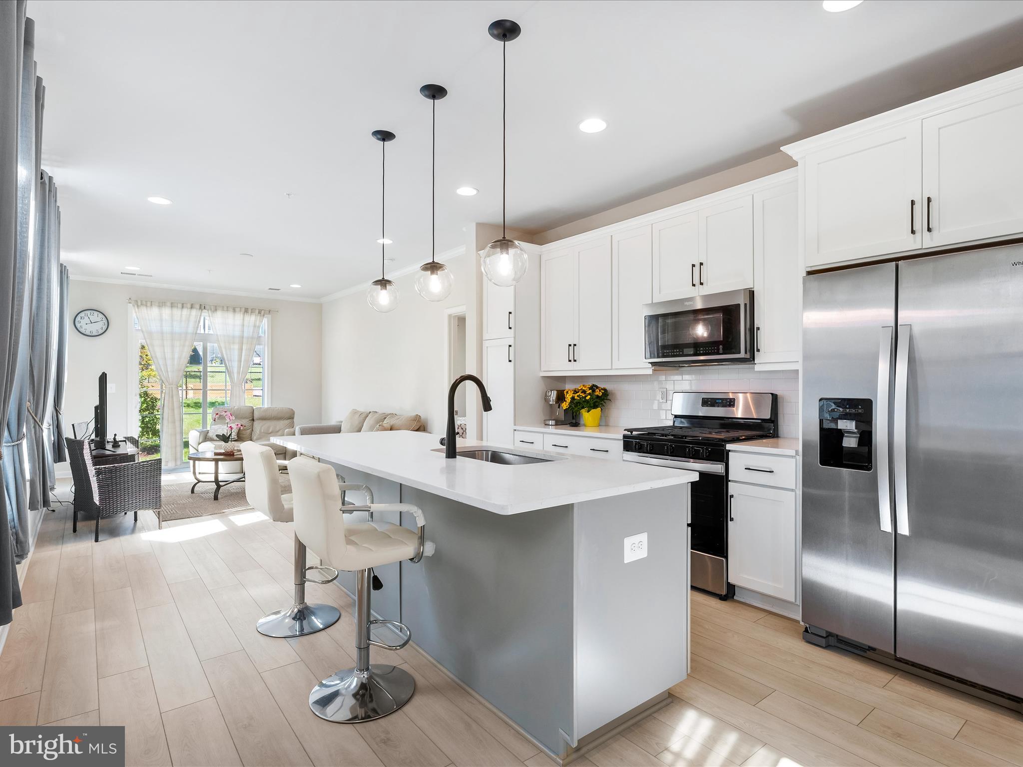 13444 Petrel Street Clarksburg, MD 20871 - Photo 6 of 45 a kitchen with kitchen island granite countertop a sink appliances and cabinets