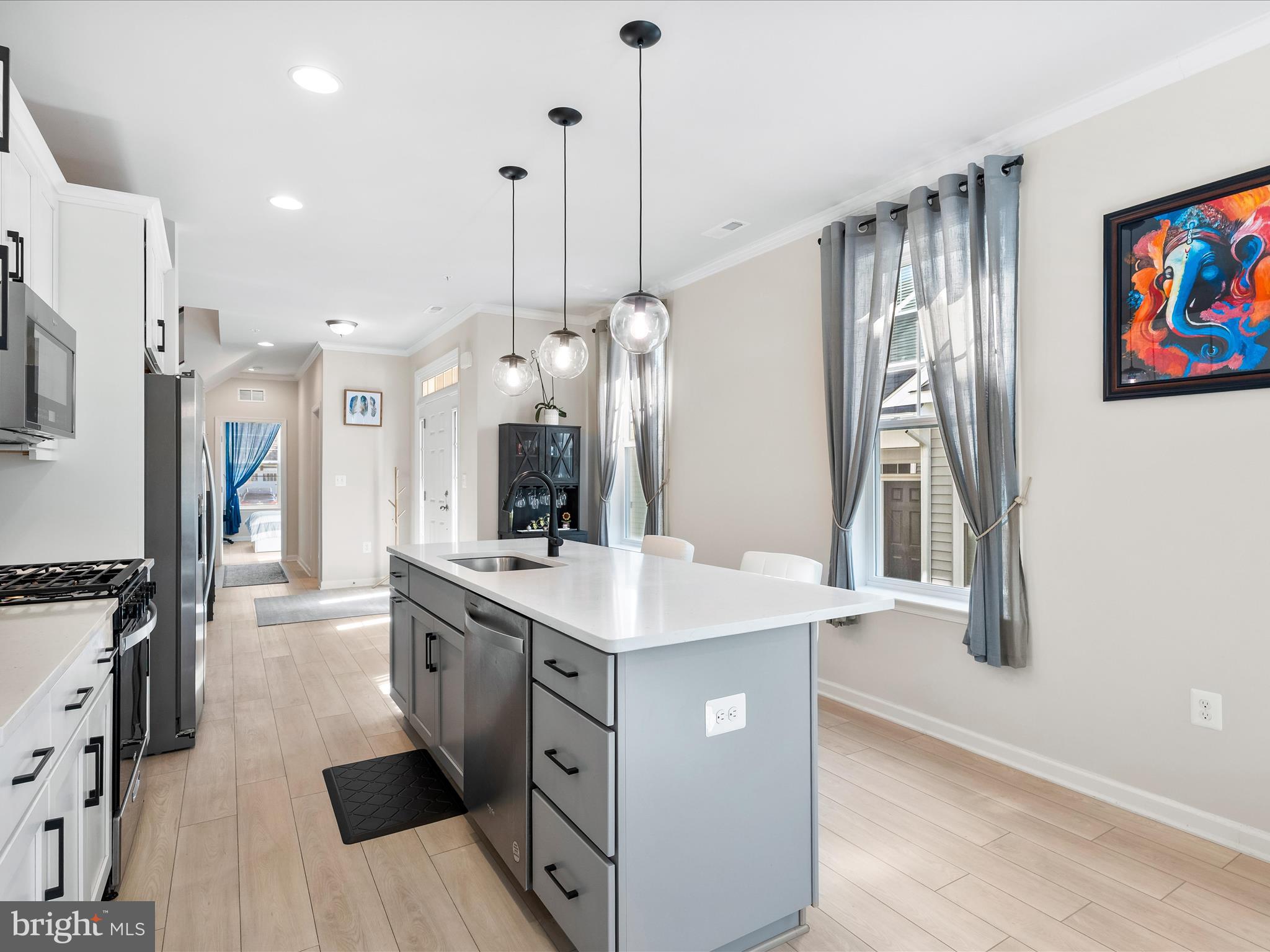 13444 Petrel Street Clarksburg, MD 20871 - Photo 7 of 45 a kitchen with stainless steel appliances granite countertop a sink a stove a refrigerator and island with wooden floor