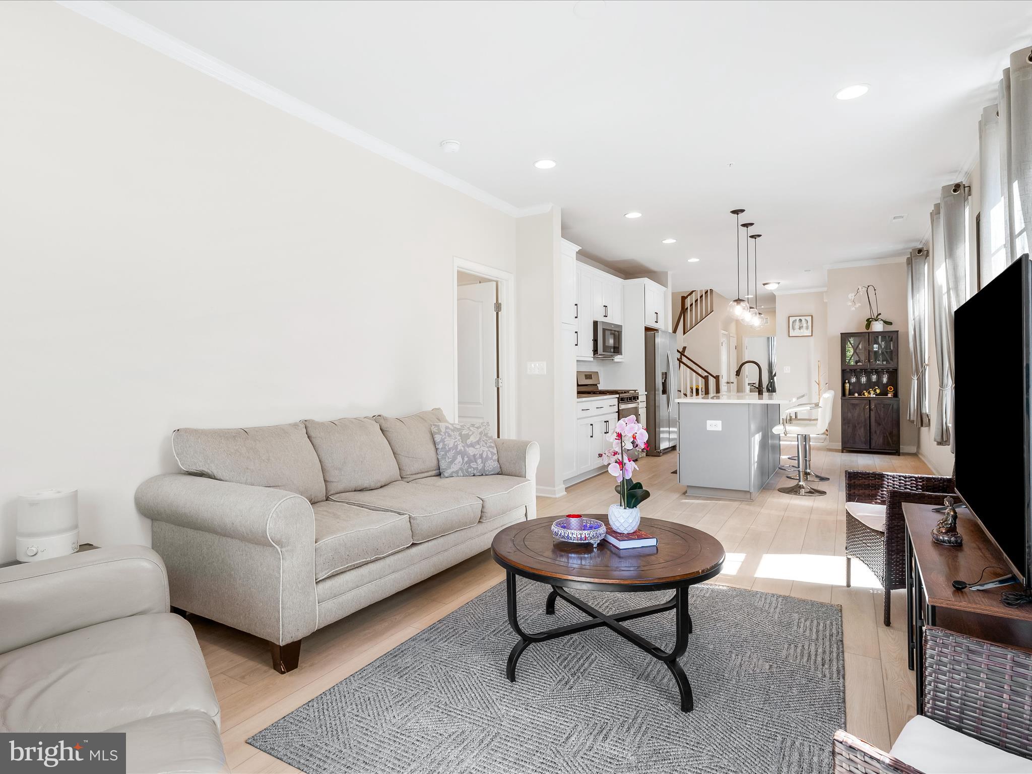 13444 Petrel Street Clarksburg, MD 20871 - Photo 9 of 45 a living room with furniture a flat screen tv and a table