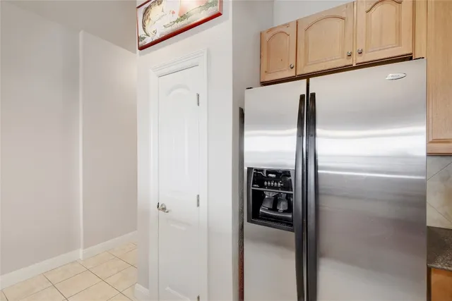 a kitchen with stainless steel appliances kitchen island granite countertop a refrigerator and a stove top oven