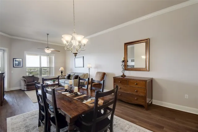 a view of a refrigerator in kitchen and white cabinets