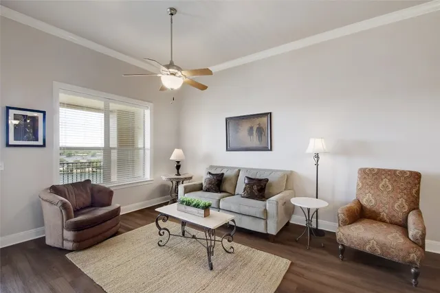 a living room with furniture a rug and a window
