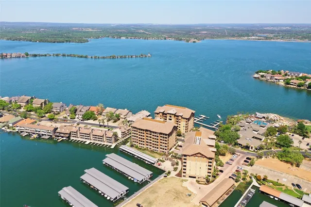 a view of a lake with couches chairs and city view