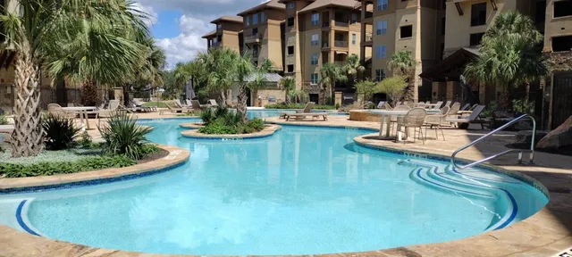 a kitchen with stainless steel appliances a sink stove refrigerator and cabinets