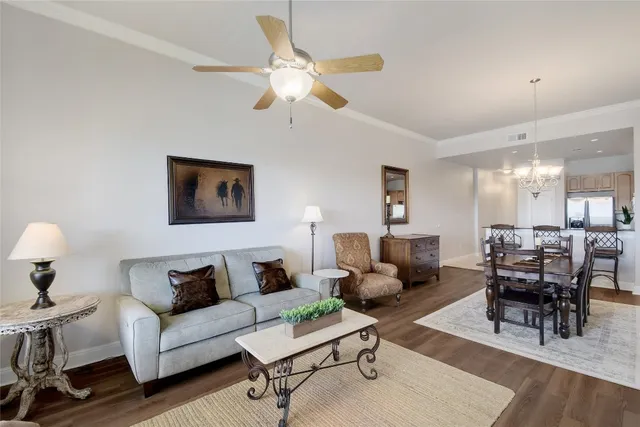 a living room with furniture a flat screen tv and a window