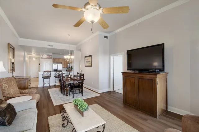 a living room with furniture and a chandelier