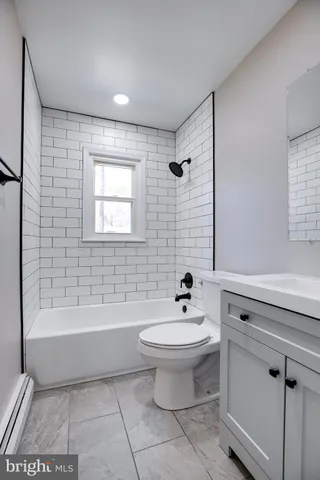 a bathroom with a sink a toilet and bathtub