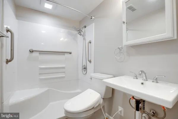 a bathroom with a sink toilet and shower
